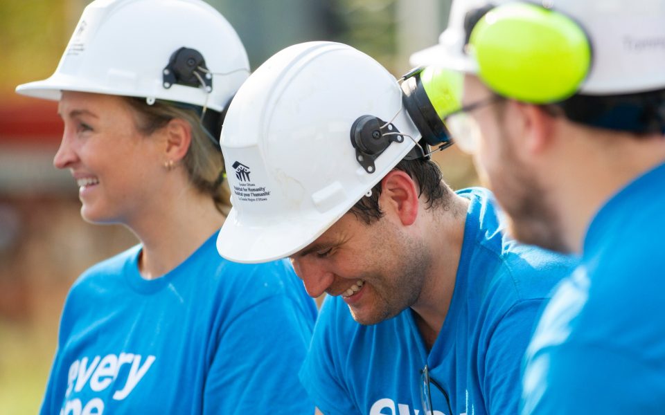 Habitat Greater Ottawa Build volunteerse wearing hard hats and smiling.