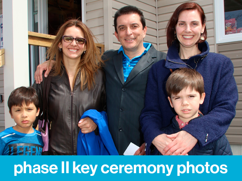 Two Habitat Partner Families and their children at the Phase II Leacross Landing Key Ceremony. Text at the bottom of the image reads, "phase II key ceremony photos".